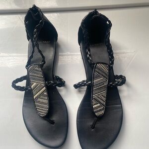 Leather Black sandals with intricate woven design.